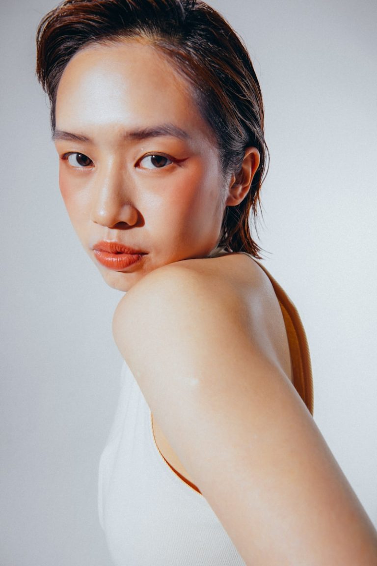 a woman in a white tank top posing for a picture
