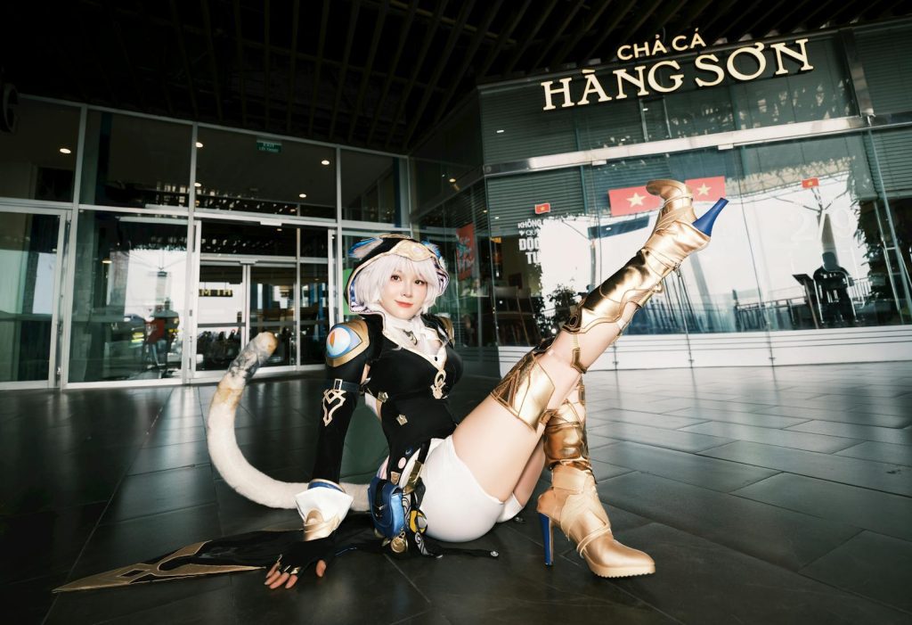 Cosplayer in detailed outfit poses at the entrance of Cha Ca Hang Son restaurant.