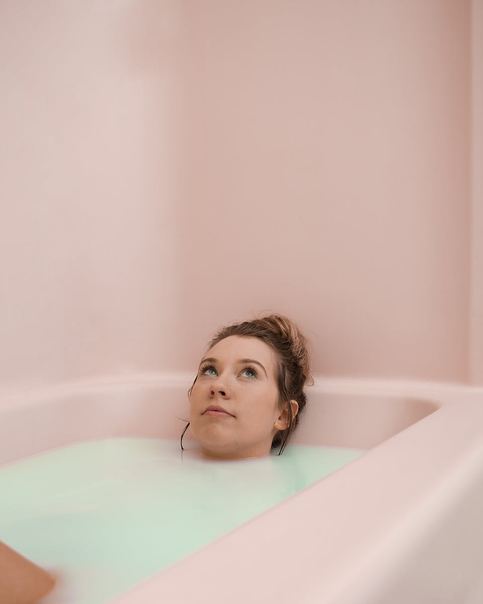An adult woman enjoys a peaceful moment while relaxing in a soothing milk bath.