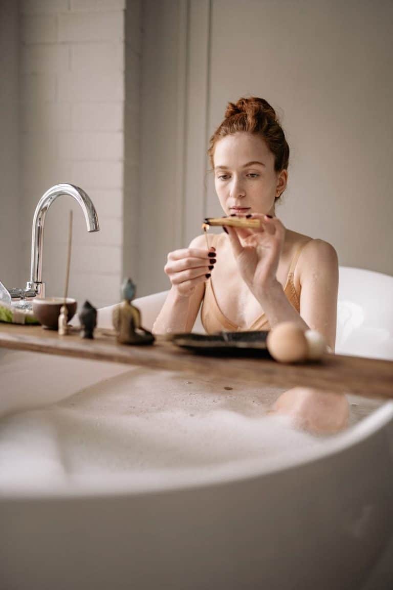 Woman enjoying a tranquil bath ritual with a focus on relaxation and self-care.