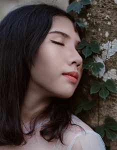 Soul Healing: A Complete Guide to Deep Emotional Recovery: A serene portrait of a young woman peacefully posing against a tree, surrounded by greenery.