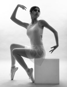 a black and white photo of a woman in a leotard
