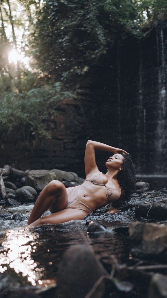 a woman in a bikini laying in the water
